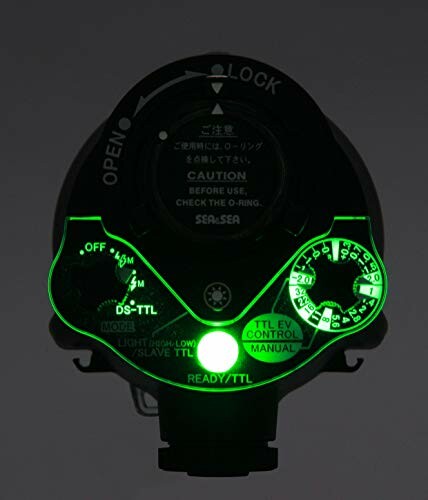 Underwater camera housing control with glowing dials.